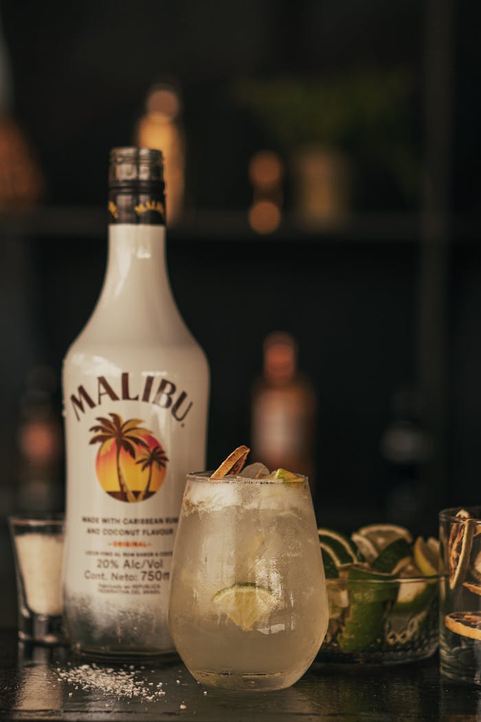 Refreshing cocktail with Malibu coconut rum, garnished with a lime slice.