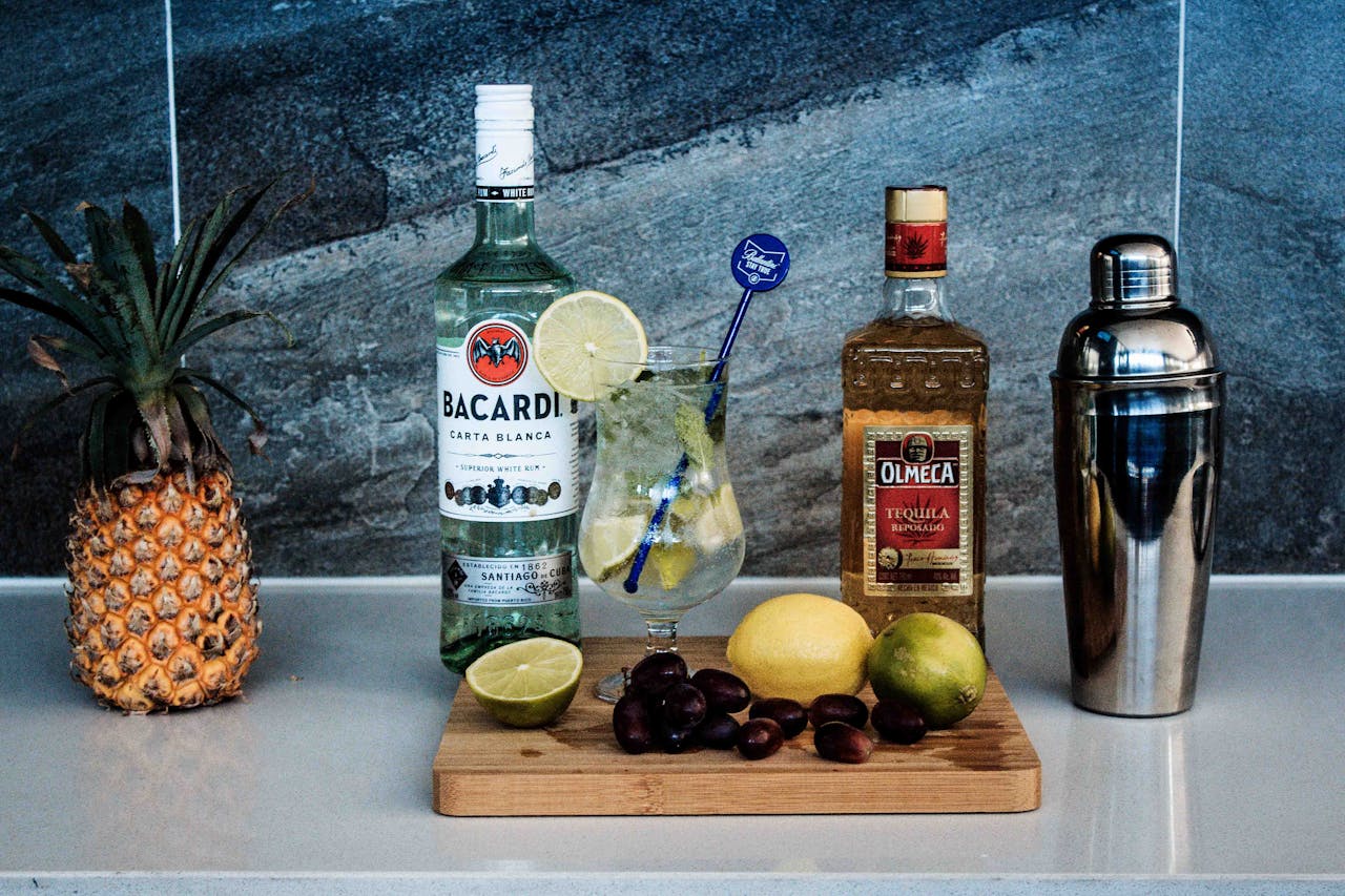 A vibrant cocktail with tropical fruits, rum, and tequila displayed on a countertop.